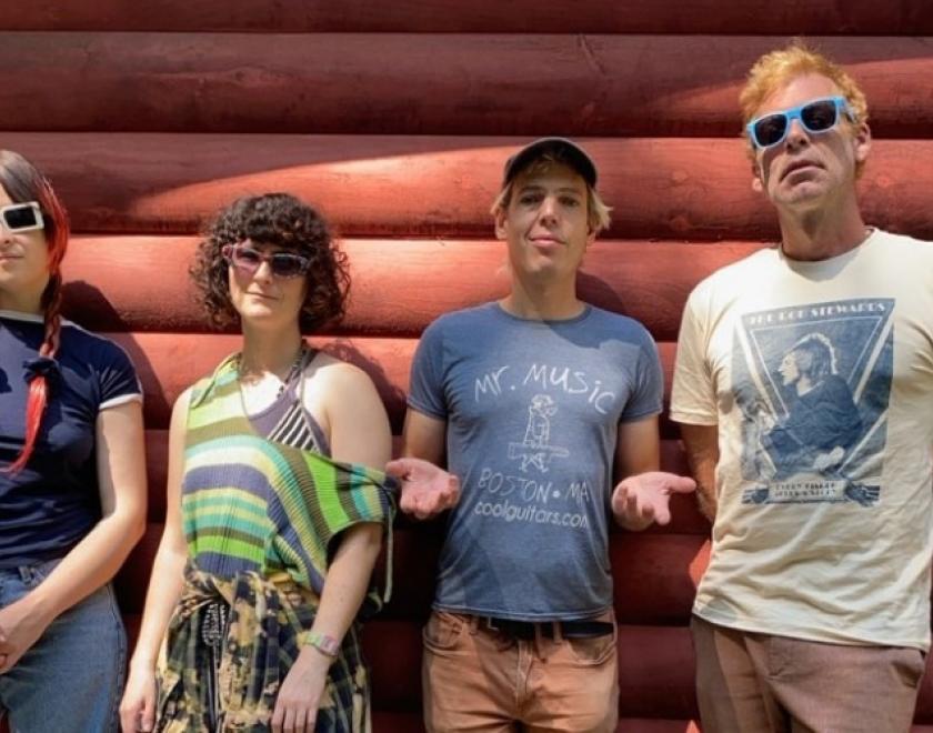 Band members of  Jeffrey Lewis & The Voltage lined up against a wall