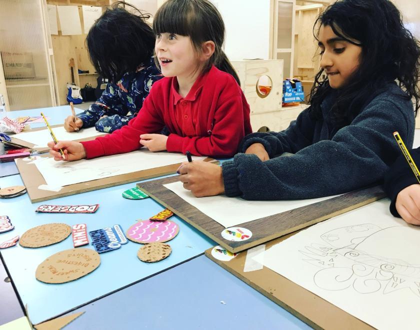 three children drawing