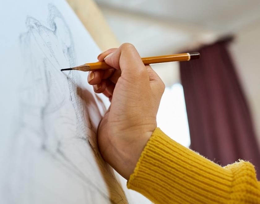 Hand sketching a person