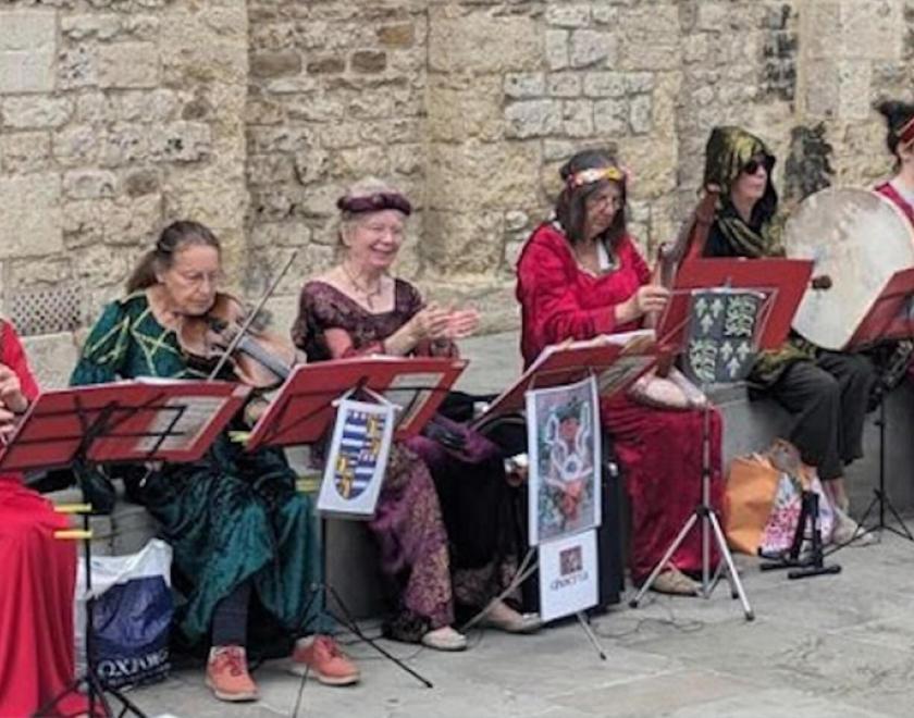people in medieval costume playing instruments