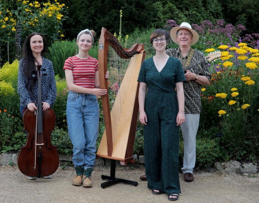 Folk band Moonrakers - three women and a man, holding a cello, harp and mandola