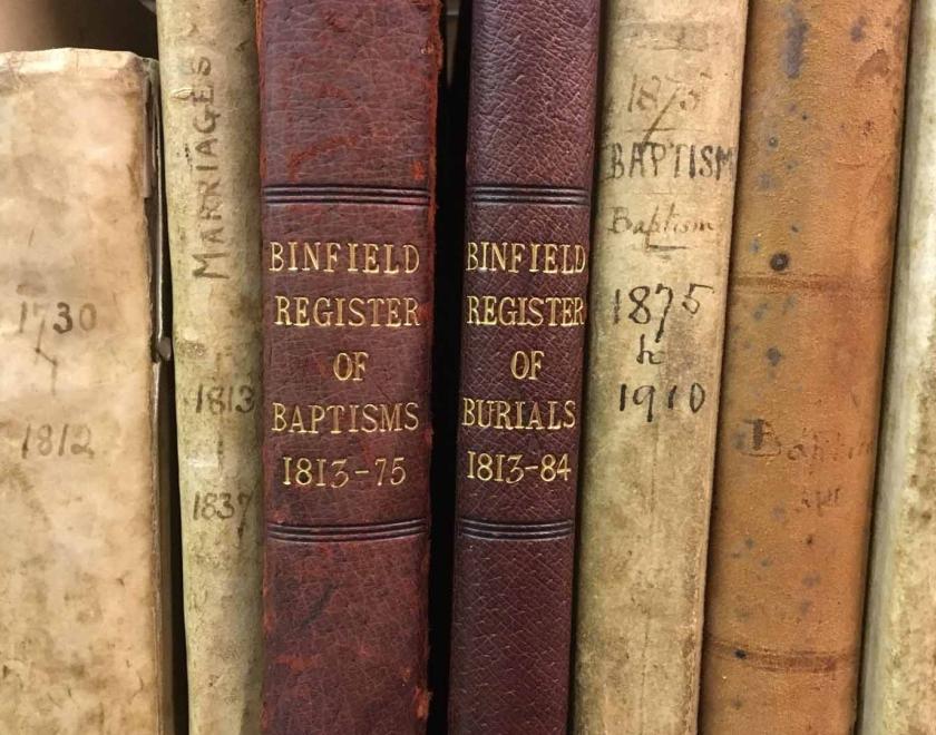 The spines of parish registers for Binfield, Berkshire, in the strong room of the Berkshire Record Office.