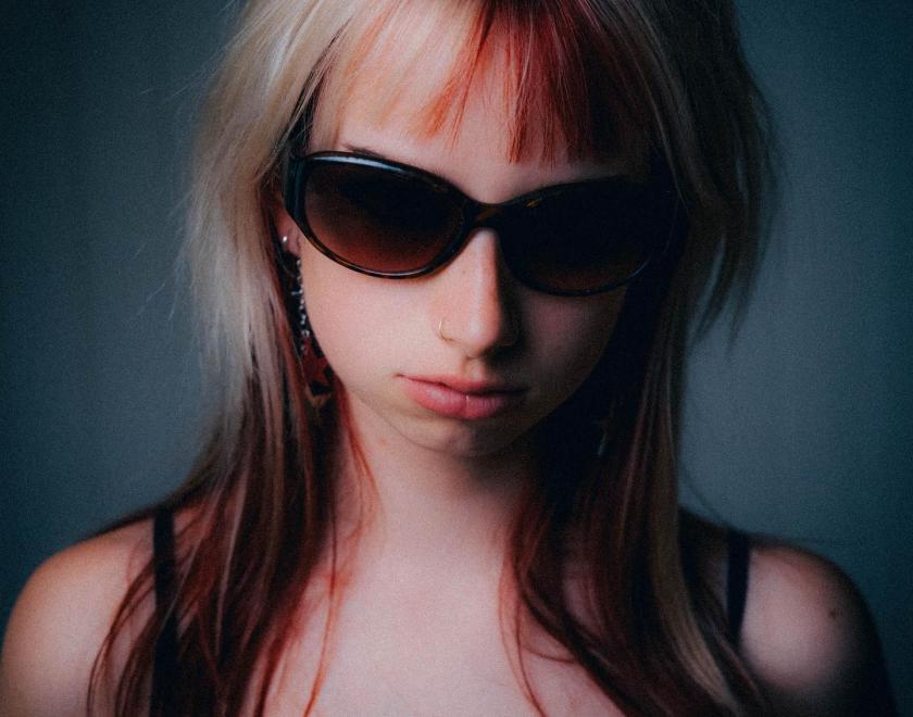 Close up photo of singer Patchy Blonde with blonde hair and dark sunglasses