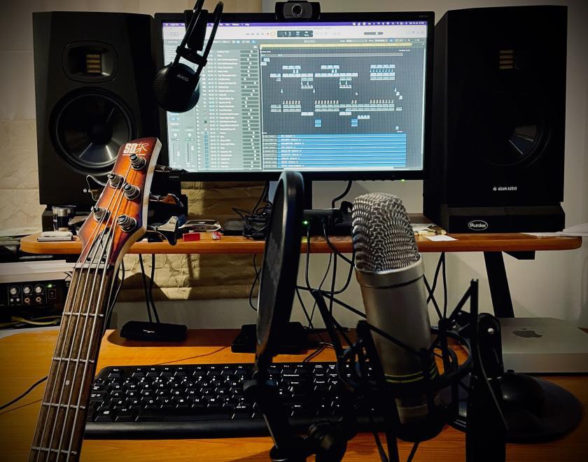 Guitars and microphones in front of a computer