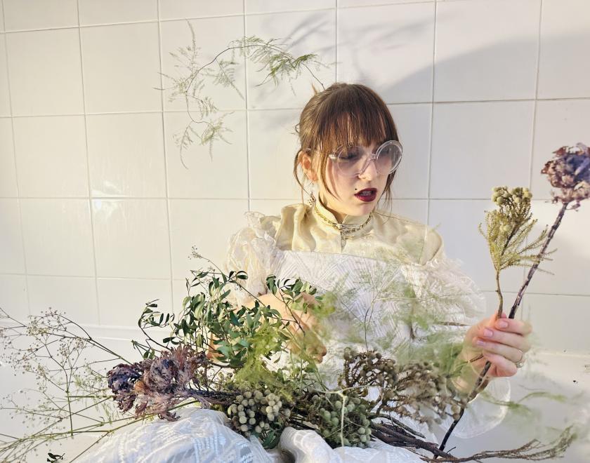 punk looking model wears bride costume with wild flowers