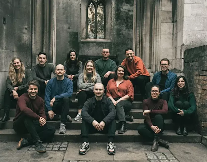 Members of SANSARA Choir, sitting on some steps
