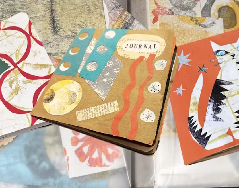 Scrap collage journals on a table