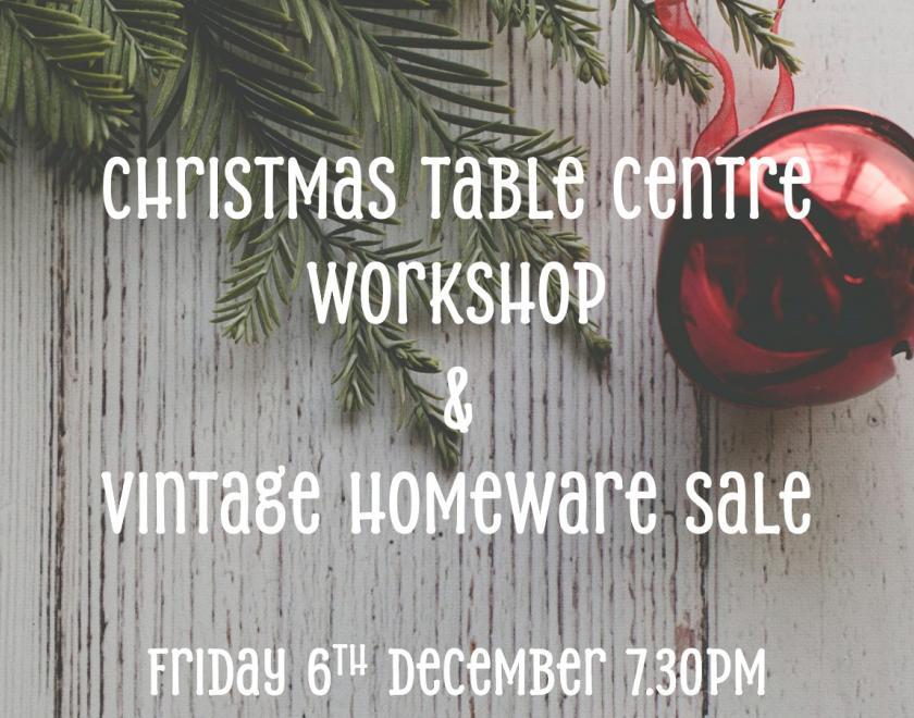 close up of a Christmas tree branch and bauble on a table