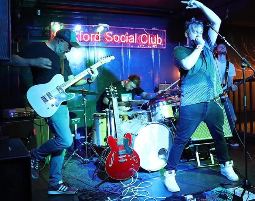 Talk In Code performing on stage at Oakford Social Club