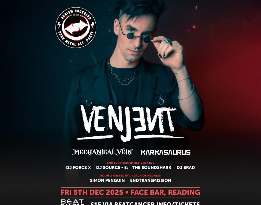 DJ Venjent pulling his sunglesses down from his eyes and looking cool while doing so