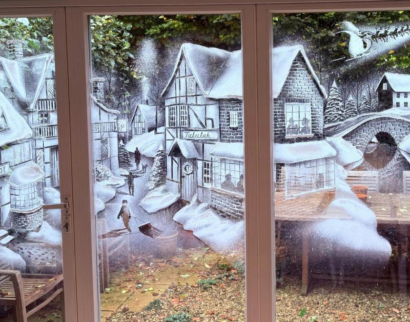 Windows painted with a snowy winter scene