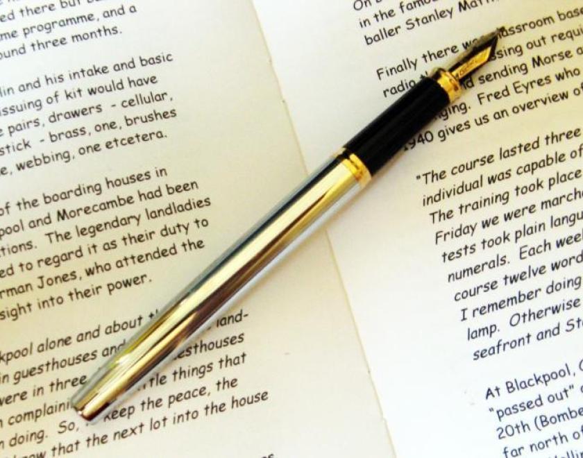 script of a book and pen